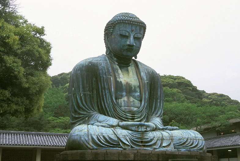 Der große Buddha von Kamakura (Daibutsu) - eine massive bronzene Buddha-Statue in meditativer Haltung, umgeben von grünen Hügeln