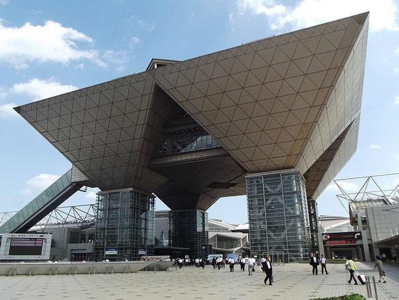 Tokyo Big Sight Kongresszentrum auf Odaiba mit charakteristischer umgekehrter Pyramiden-Architektur und Besuchern auf dem Vorplatz